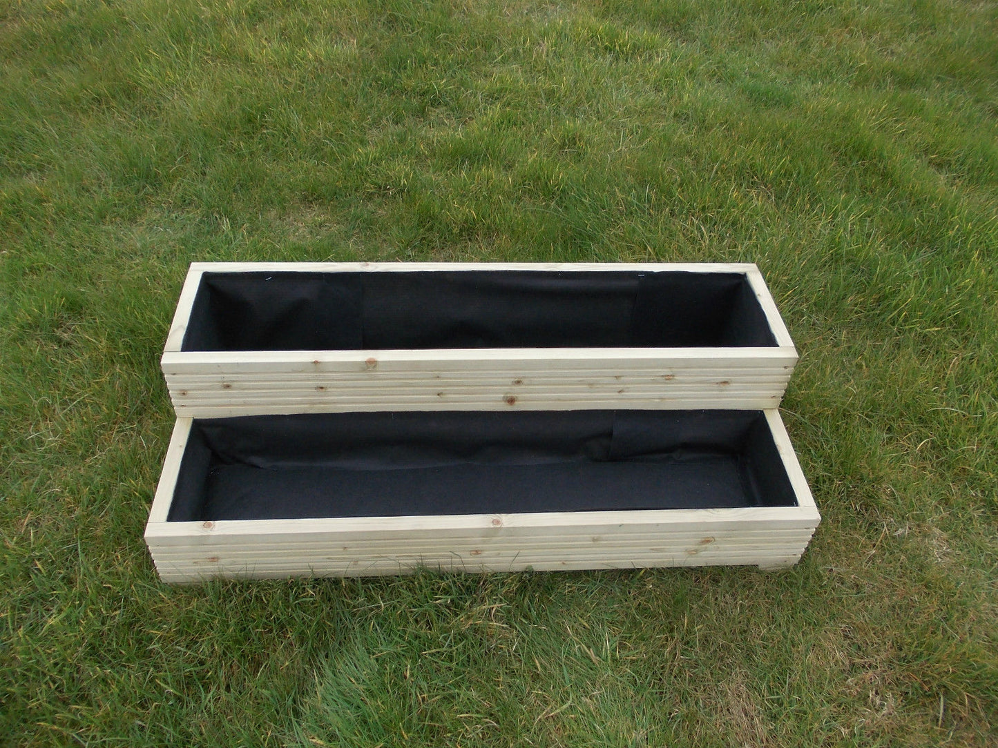 Wide step decking garden planter.